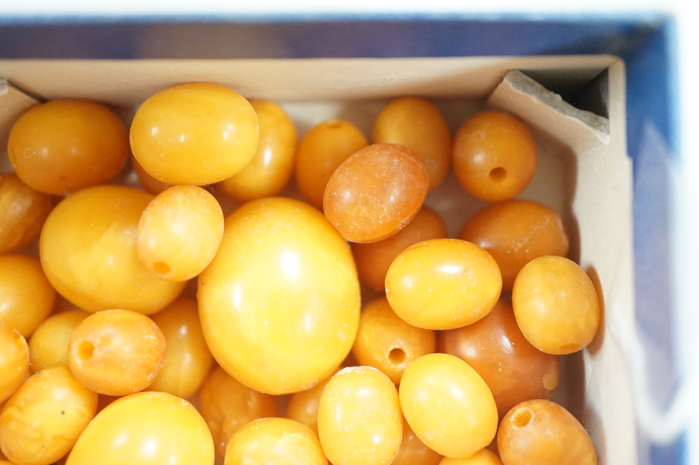 A group of loose graduated oval amber beads, 42 grams.